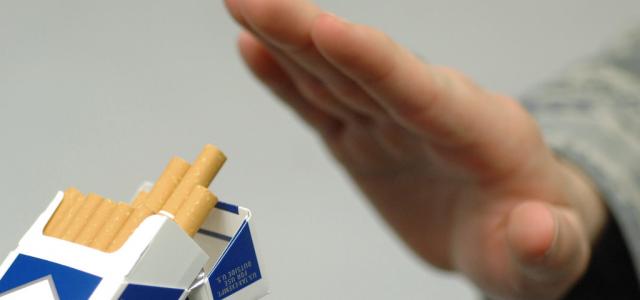 Hand refusing offered cigarettes